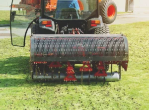 worker-operating-soil-aeration-machine-on-grass-lawn-wendell-id